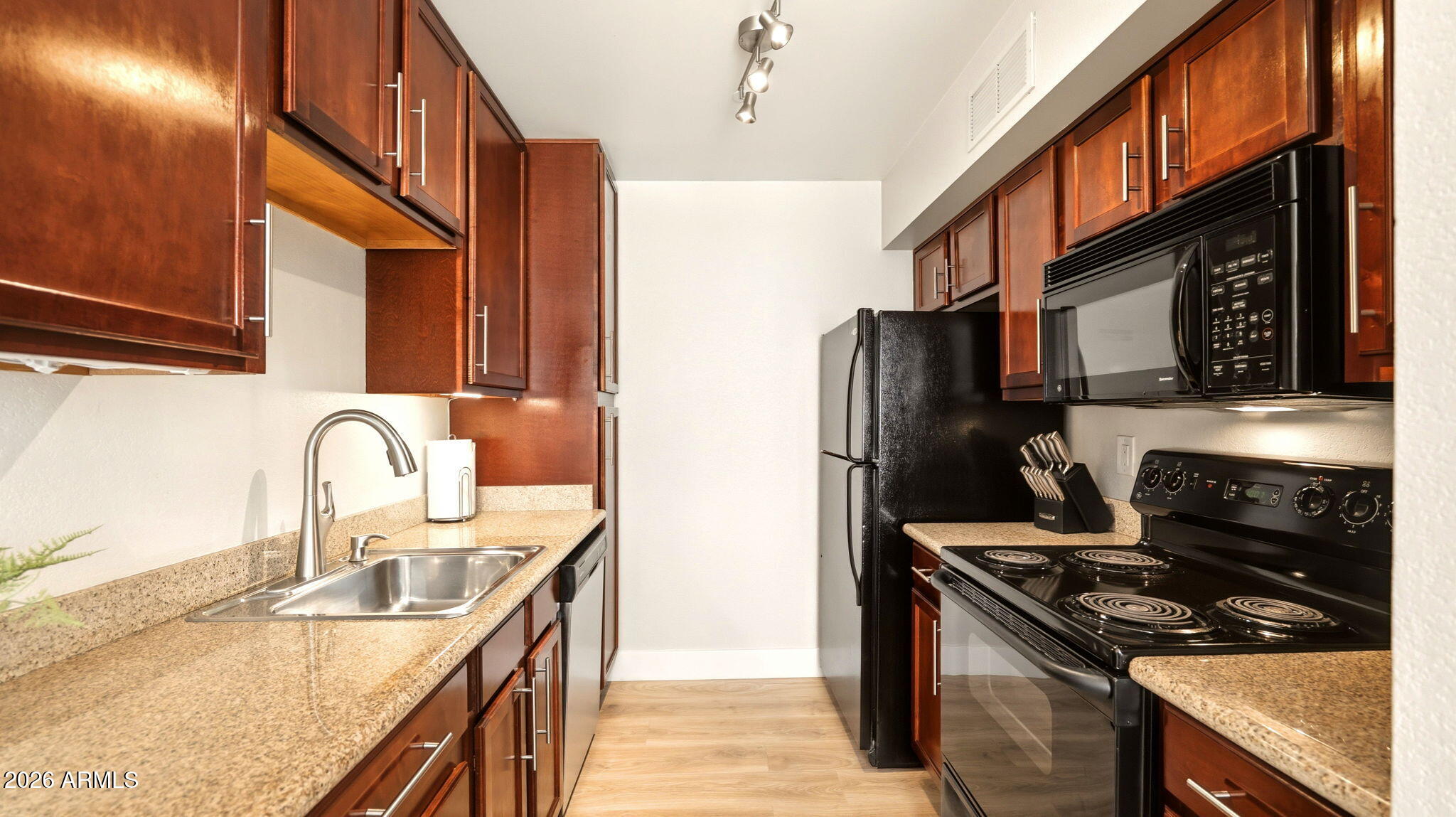Kitchen with granite counters and full appliance package at 3600 N Hayden Rd #2902