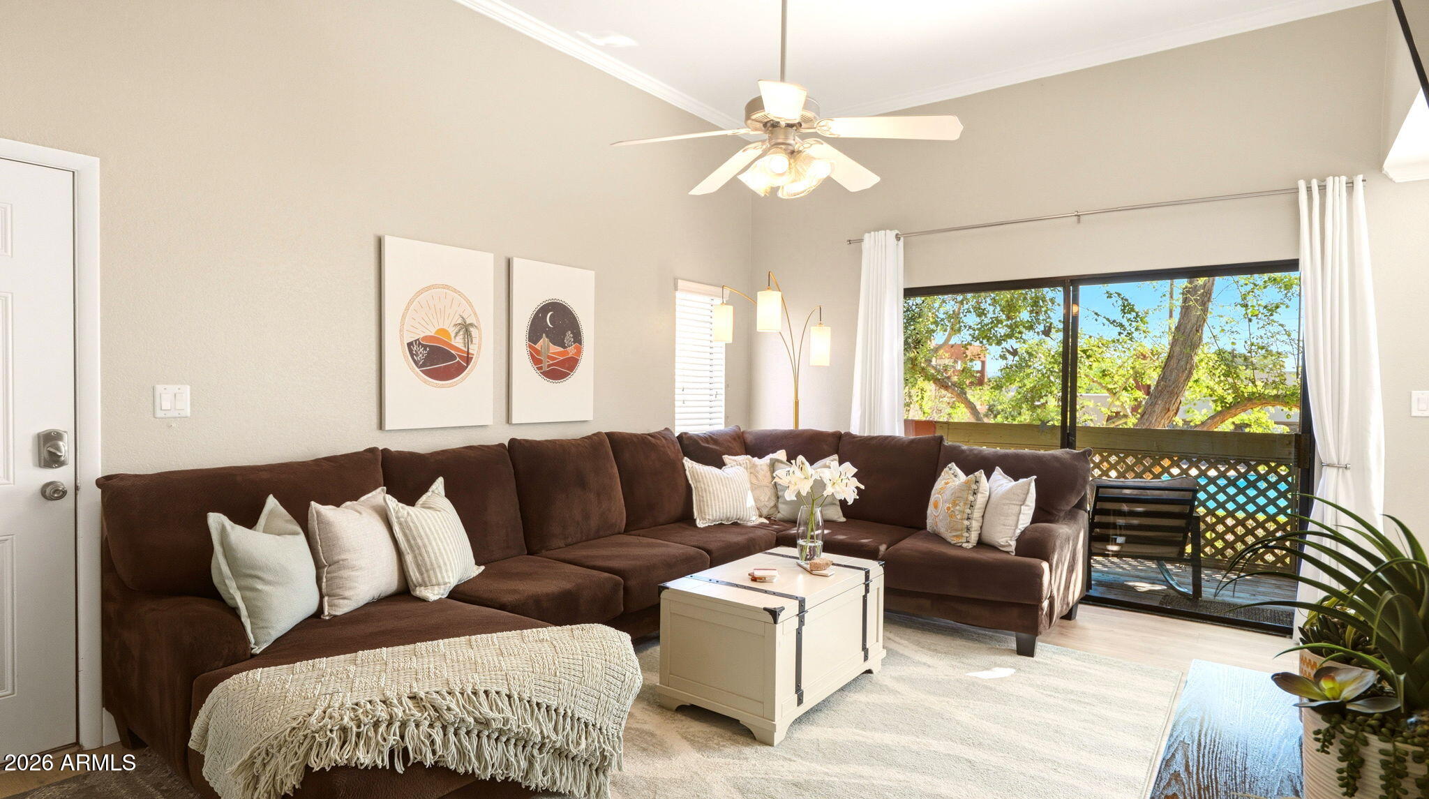 Living room with sectional seating and sliding doors to the private balcony